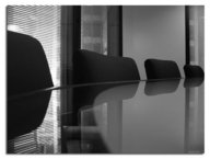 A shiny reflective table with comfy chairs in the background